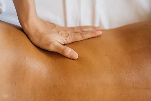Client booking a professional home massage service in Okhla, Delhi using a smartphone and selecting a preferred appointment.