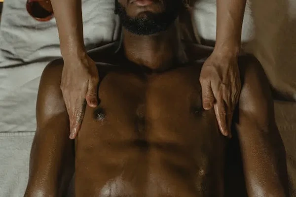 Therapist performing targeted muscle tension relief massage on a client's back