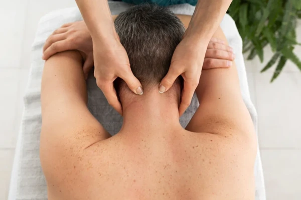 Professional male massage therapist delivering doorstep spa therapy at a hotel room in Gurgaon.