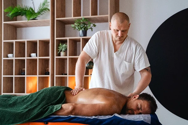 Professional male therapist providing a relaxing full body massage in Hauz Khas, Delhi.