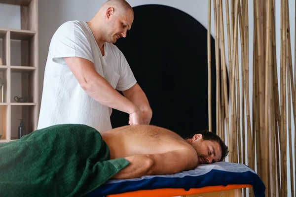 Professional male masseur preparing organic oils for home and hotel doorstep massage service in Delhi NCR