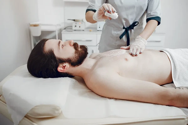 Experienced male massage therapist discussing pressure preferences for personalized massage in Delhi NCR
