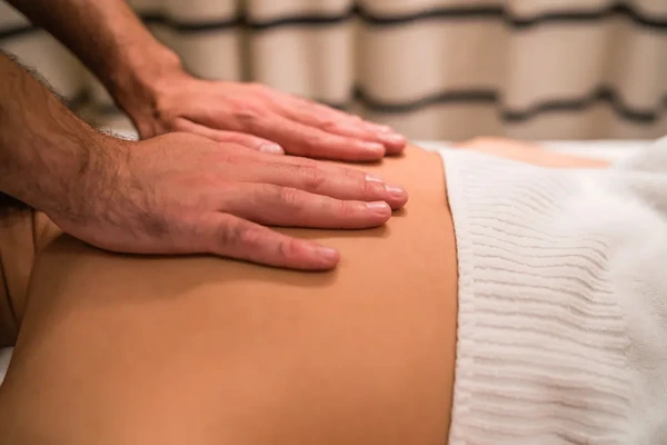Doorstep male to male full body massage therapist preparing fresh linens for home service in Noida