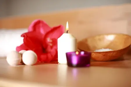 Essential oils setup and soothing aromatherapy body massage delivered by professional therapist