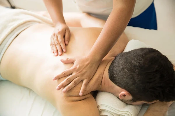 Satisfied male client enjoying professional doorstep massage service with certified therapist in Delhi NCR