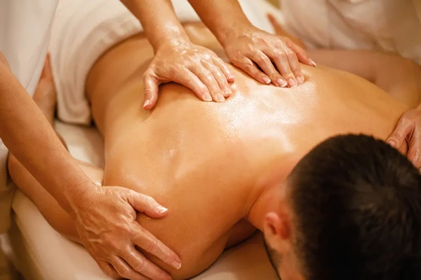Working professional receiving a stress-relief back and shoulder massage in Delhi NCR.