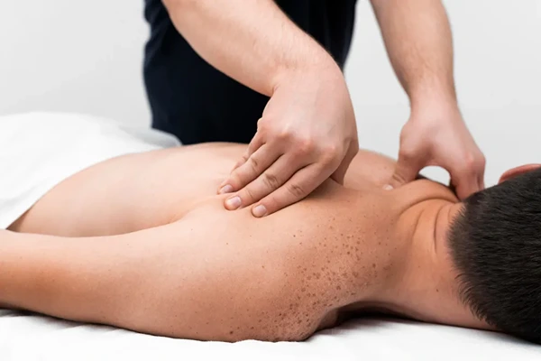 Client receiving gentle Swedish massage with smooth strokes in Delhi home session.